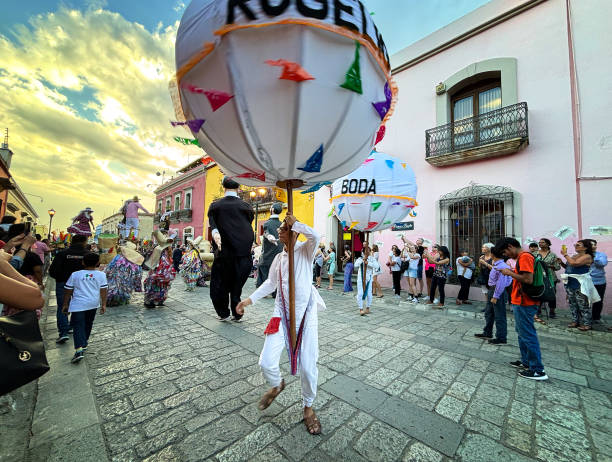 Oaxaca, Mexico: Onlookers watch a colorful parade through the streets of downtown Oaxaca celebrating a wedding.