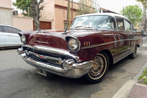 Bernal, Argentina - Sept 18, 2022: Old red maroon 1957 Chevrolet Bel Air sedan four door at a classic car show in the street