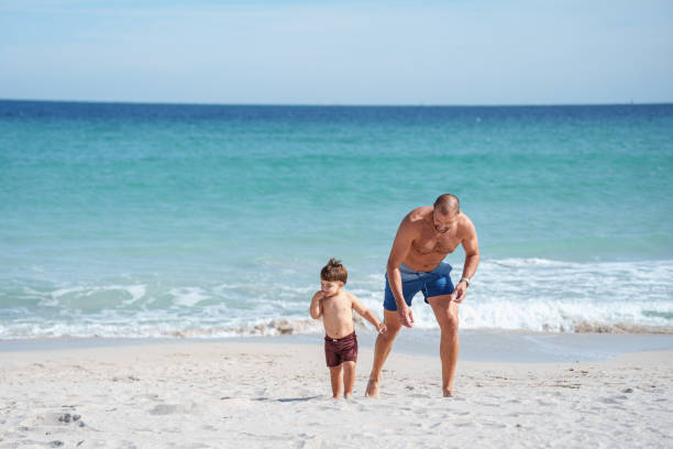 istock Father plays with toddler son on the beach 2038909239
