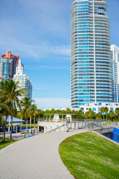 istock Father carries son down city boardwalk in Florida 2038909240