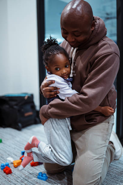 istock Loving father hugs toddler daughter while playing with blocks 2038909811