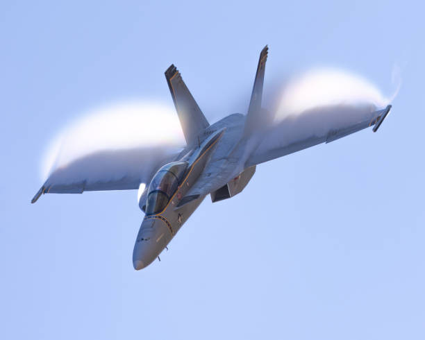 istock F-18 Hornet approaching in a high G maneuver, with condensation clouds over  the wing 2038918326