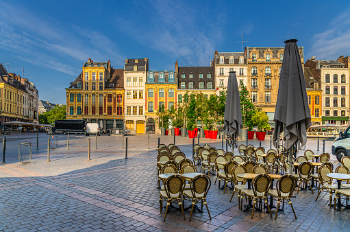 Lille cityscape with La Grand Place square in city center, Flemish mannerist architecture style buildings, tables and chairs of street restaurant, Nord department, Hauts-de-France Region, France