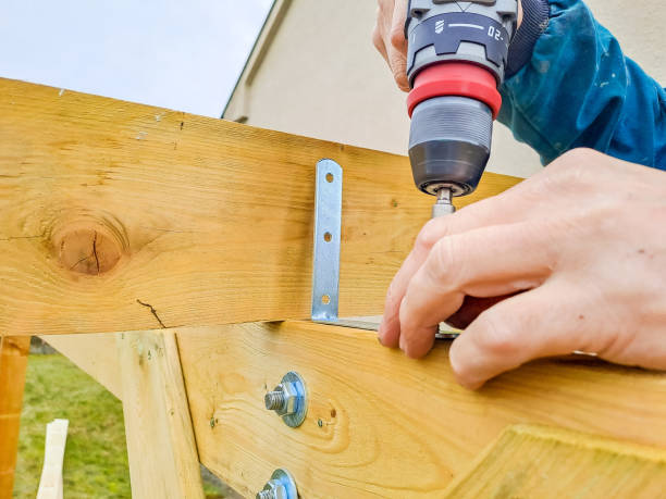 istock Worker using drill working on construction of wood frame house, gazebo 2038968120