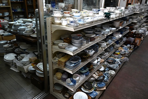 Japanese antique store is filled with a variety of products such as pottery, antiques, and miscellaneous goods.