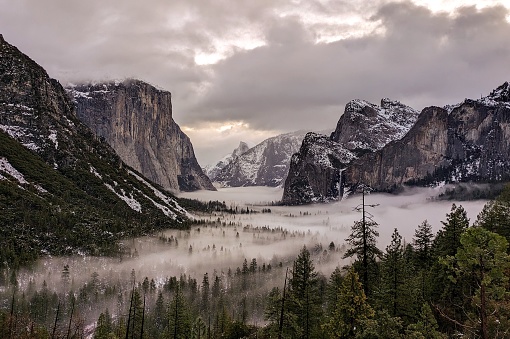 Valley fog enhances the landscape as seen from the iconic Tunnel View in Yosemite National Park, CA, USA