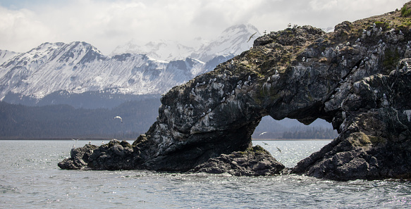 Heart shaped rock arch near Gull Island in Kachemak Bay near Homer Spit in Alaska United States