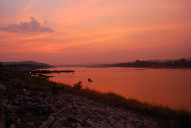 Scenic view dramatic beautiful sunset sky. Natural Sunset Sunrise on meadow silhouette shadow dark land. Vibrant dramatic sky on sunset, dawn, sunrise in Countryside. Landscape Colorful Sky At Sunset
