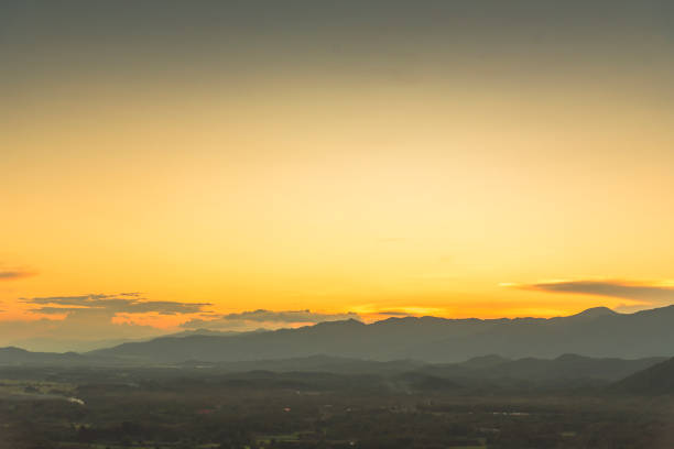 Scenic view dramatic beautiful sunset sky. Natural Sunset Sunrise on meadow silhouette shadow dark land. Vibrant dramatic sky on sunset, dawn, sunrise in Countryside. Landscape Colorful Sky At Sunset