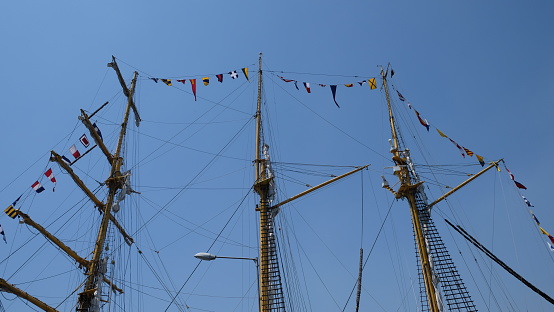 A sailing ship's mast filled with various national flags