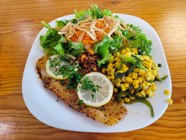 Breaded Fish Fillet with Salad on Wooden Table, Mexico