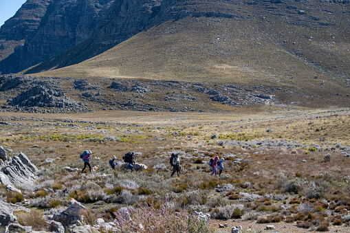 An active family enjoys hiking with their children in the beautiful Cederberg Mountains near Cape Town, South Africa