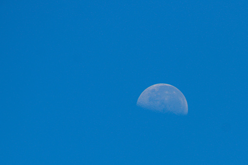 the moon in the blue sky