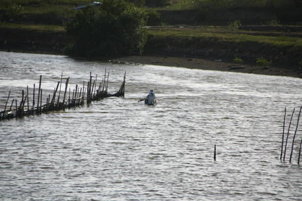 Banda Aceh, 07/29/2019, Fishermen rowing boats on the river to catch fish at sunset on the Syiah Kuala River.
