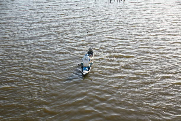 Banda Aceh, 07/29/2019, Fishermen rowing boats on the river to catch fish at sunset on the Syiah Kuala River.