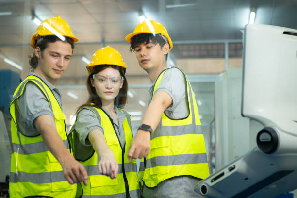 group of factory workers greeting each other with joint hands together in warehouse - computer control room hardhat computer monitor 뉴스 사진 이미지