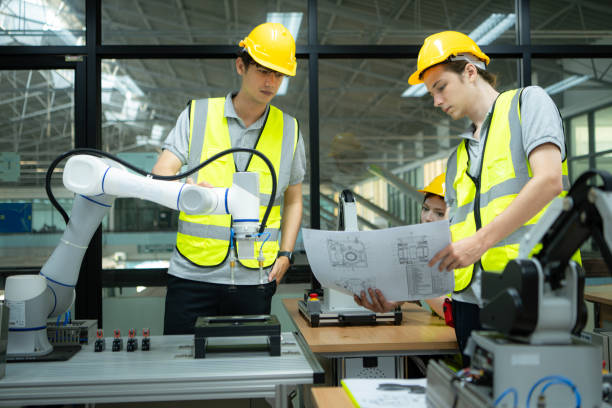 istock Group of engineers and technicians learning the technology to control hand robots for industrial usage. 2039435028