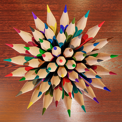 A bunch of colored wooden pencils in a plastic mug.
