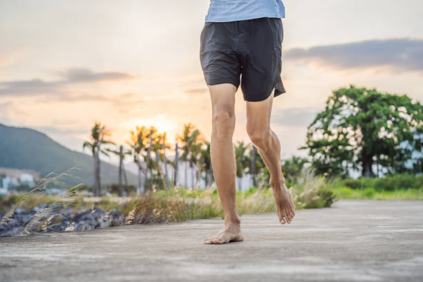istock A man runner is engaged in jogging on a concrete path without shoes, without sneakers, for health 2039464516