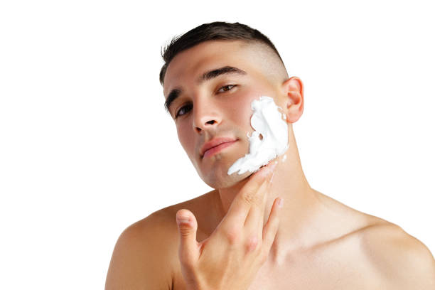 istock Young handsome man applying shaving foam against white background 2039481002