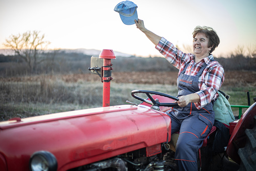 A woman farmer is a tractor driver