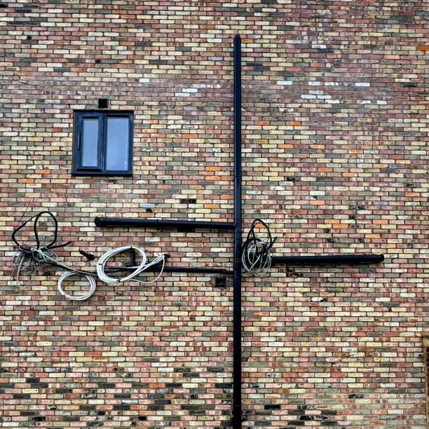 Red brick building wall with windows, blue sky, part of, sunlight
