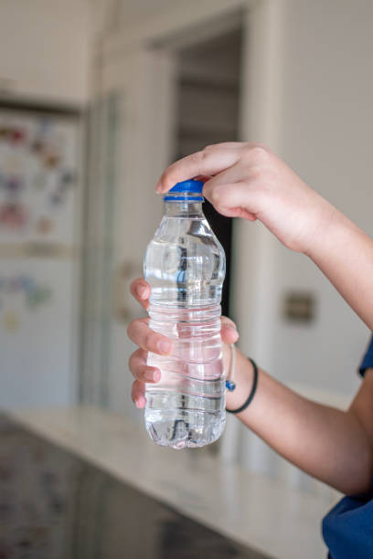 istock Water bottle on human hand 2039498760