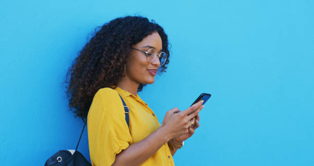 istock Mockup space, internet and woman with a smartphone, typing and mobile app on a blue studio background. Person, girl or model with a cellphone, connection and network with website info or social media 2039500822