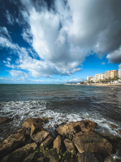 A beautiful view at clouds over Mediterranean Sea and coast of Marbella in Spain.
