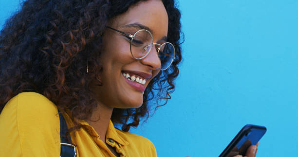 istock Happy, mockup space and woman with a smartphone, typing and search internet on a blue studio background. Person, smile and model with a cellphone, mobile user and email with digital app, sms and text 2039506505