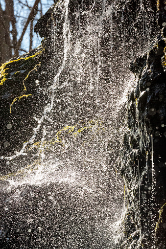 High shutter speed exposure of Blackledge Falls captures a haze of water drops cascading down the rocky cliff face, in Glastonbury, Connecticut.