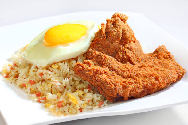 delicious ham chicken, egg, fried rice in white plate on brown background premium western cafe halal food menu for restaurant