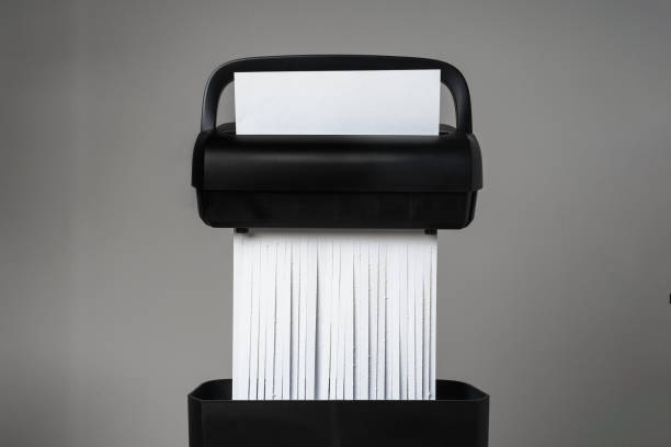 istock Black paper shredder cutting paper on gray background 2039518618