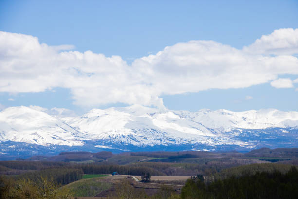istock Hilly farmland and snow covered mountains 2039521234