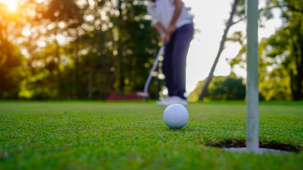 istock Golfer playing golf in the evening golf course, on sun set evening time. 2039534353