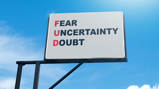 Billboard view of 'Fear Uncertainty Doubt' word with blue sky background. Business fear uncertainty doubt concept