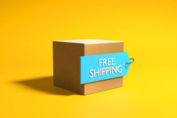 Cardboard cargo box with free shipping label on yellow background.