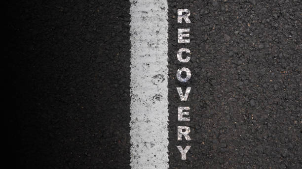 istock 'Recovery' text on the asphalt road 2039578980