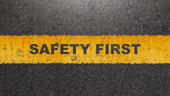'Safety first' text on the asphalt road. Safety first concept