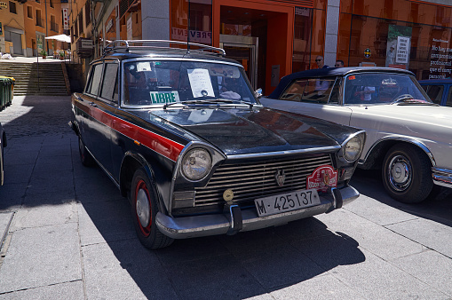 16-06-2013 Segovia, Spain - A vintage SEAT taxi, black and red, stands out at an antique car gathering