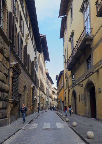 06-11-2013 Florence, Italy - Pedestrians stroll along enchanting streets adorned with impressive facades in Florence