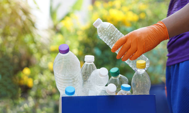 istock Hand holds used plastic bottle to put in junk bin for recycling. Concept, sorting garbage campaign before throw away 2039590488
