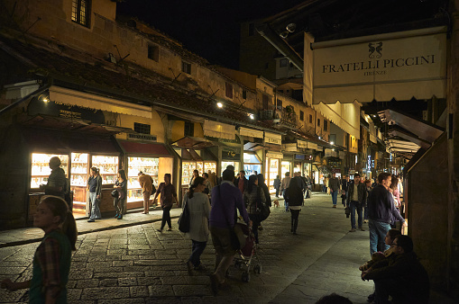 07-11-2013 Florence, Italy - Pedestrians explore shops along Florence's Ponte Vecchio, creating a magical nocturnal ambiance