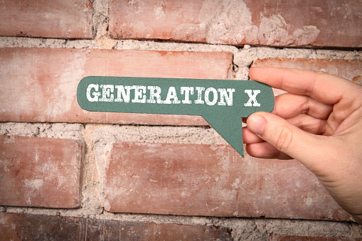 Generation X Concept. Green speech bubble with text on a red brick background.