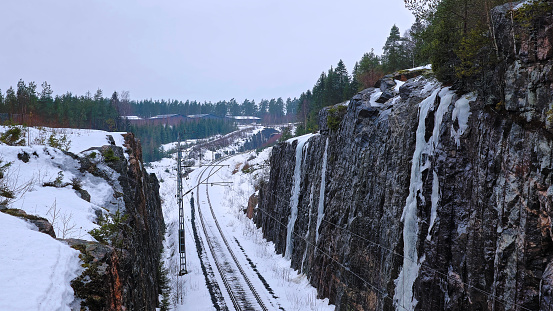 Railroad tracks blanketed in winter snow in Karjaa, Raasepori, Finland, Europe.