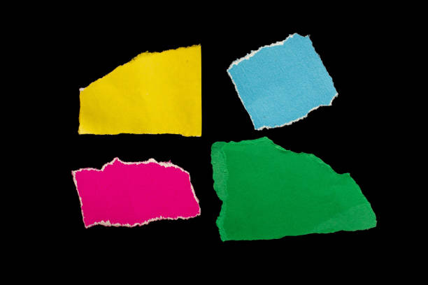 Colorful ripped paper pieces isolated on black background. Torn paper with space.