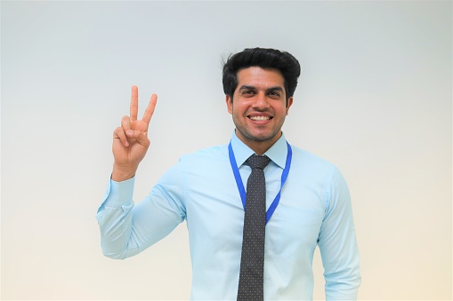 Portrait of Indian businessman giving thumbs up