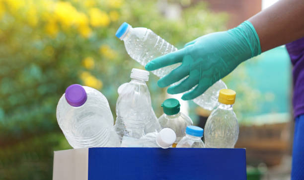 istock Hand holds plastic bottle to put in junk bin for recycling. Concept, sorting garbage campaign before throw away for reuse or recycle. Environment conservation. Eco friendly activity. 2039654627
