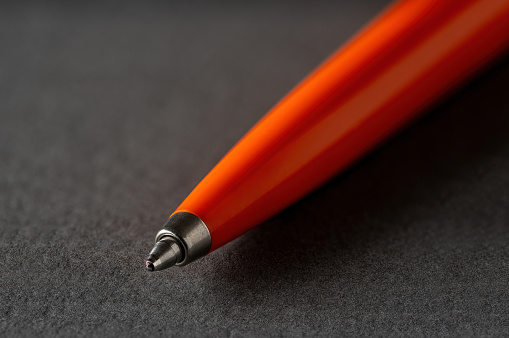 Close up of a vintage style Ballpoint pen on a dark gray background