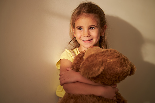 Beautiful girl hugging her Teddy Bear.